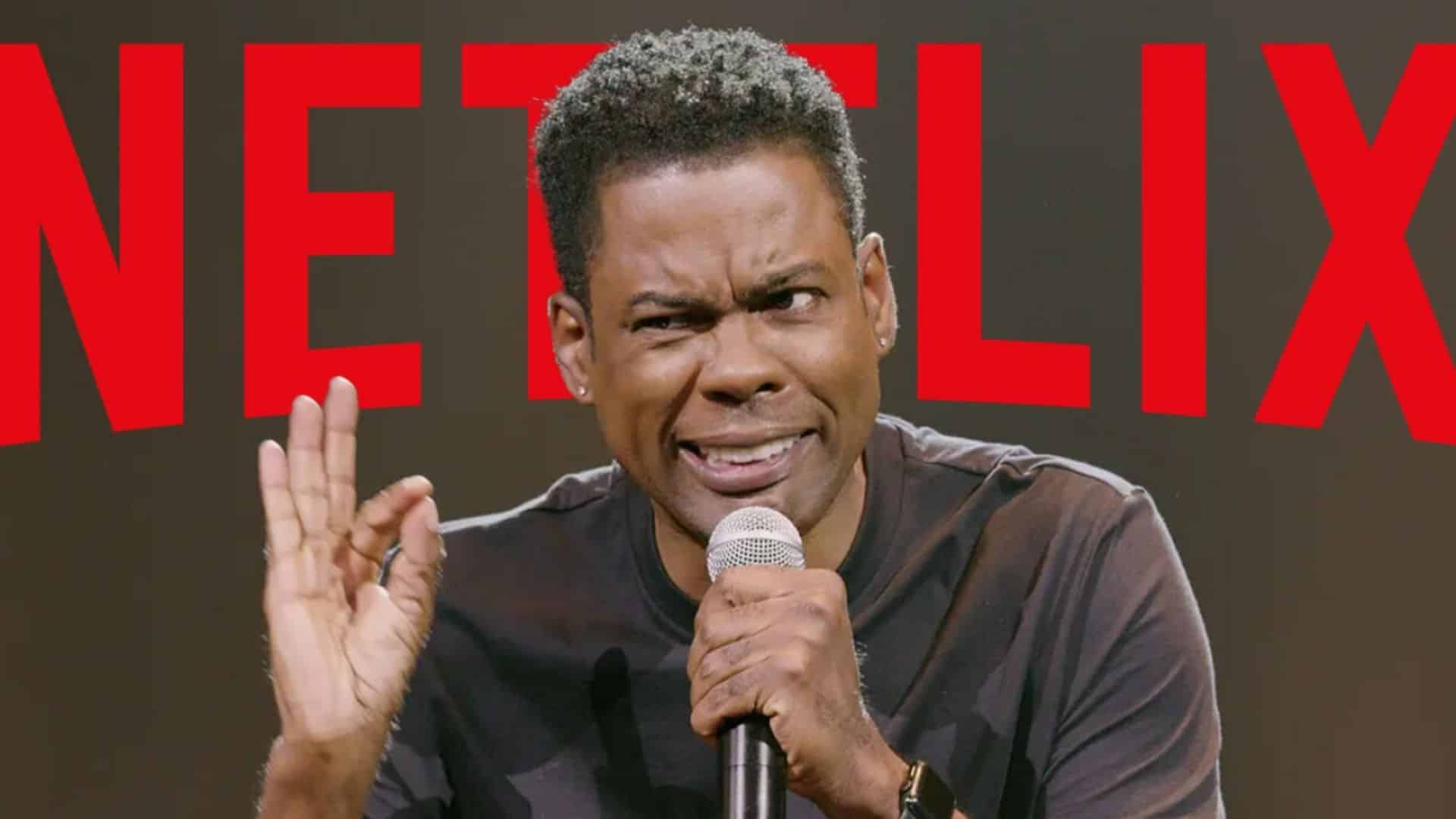 Chris Rock performing a stand-up comedy special for Netflix with a microphone