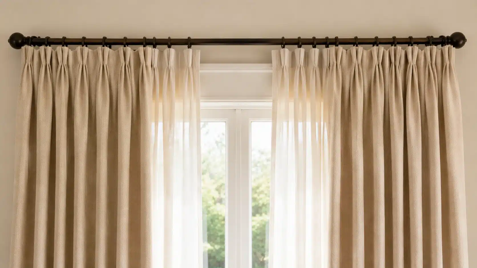 Curtains arranged on a rod showing proper fullness with soft folds for measuring curtain width accurately