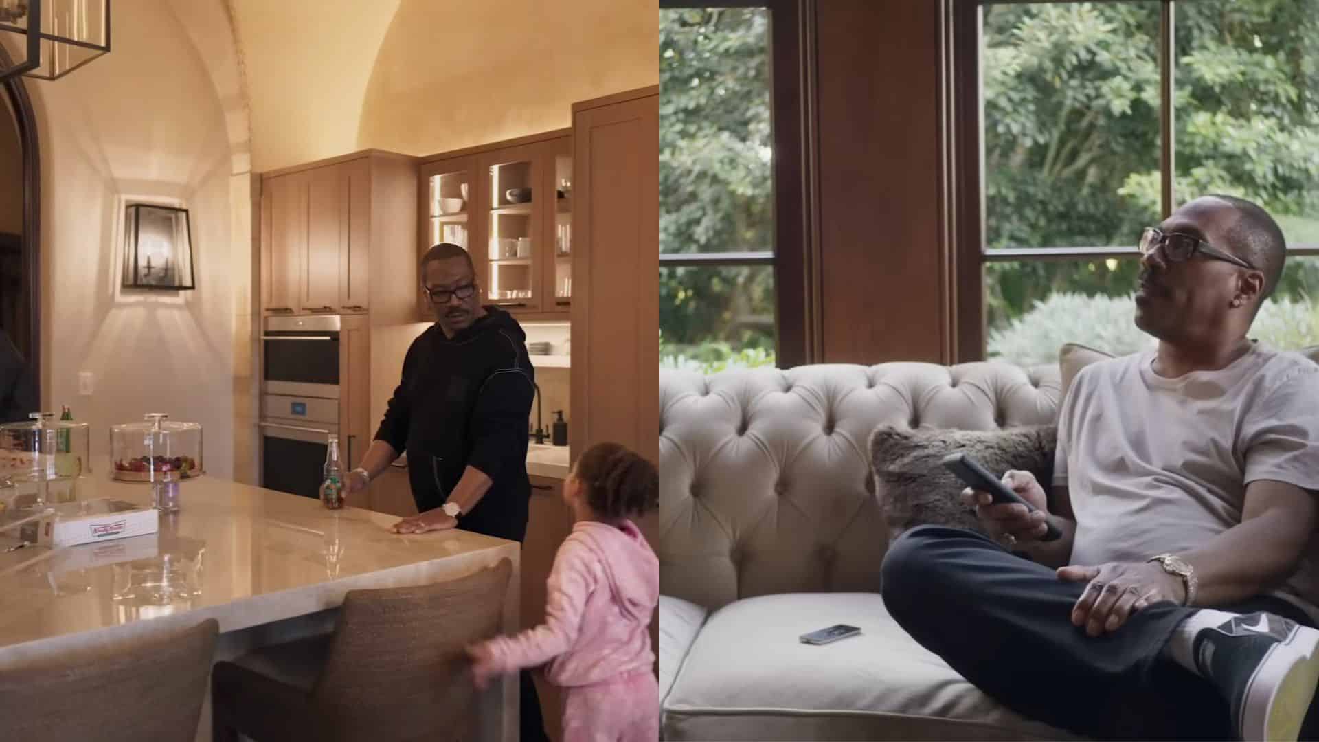 Eddie inside his luxury home, shown in a modern kitchen and seated on a sofa beside large windows.