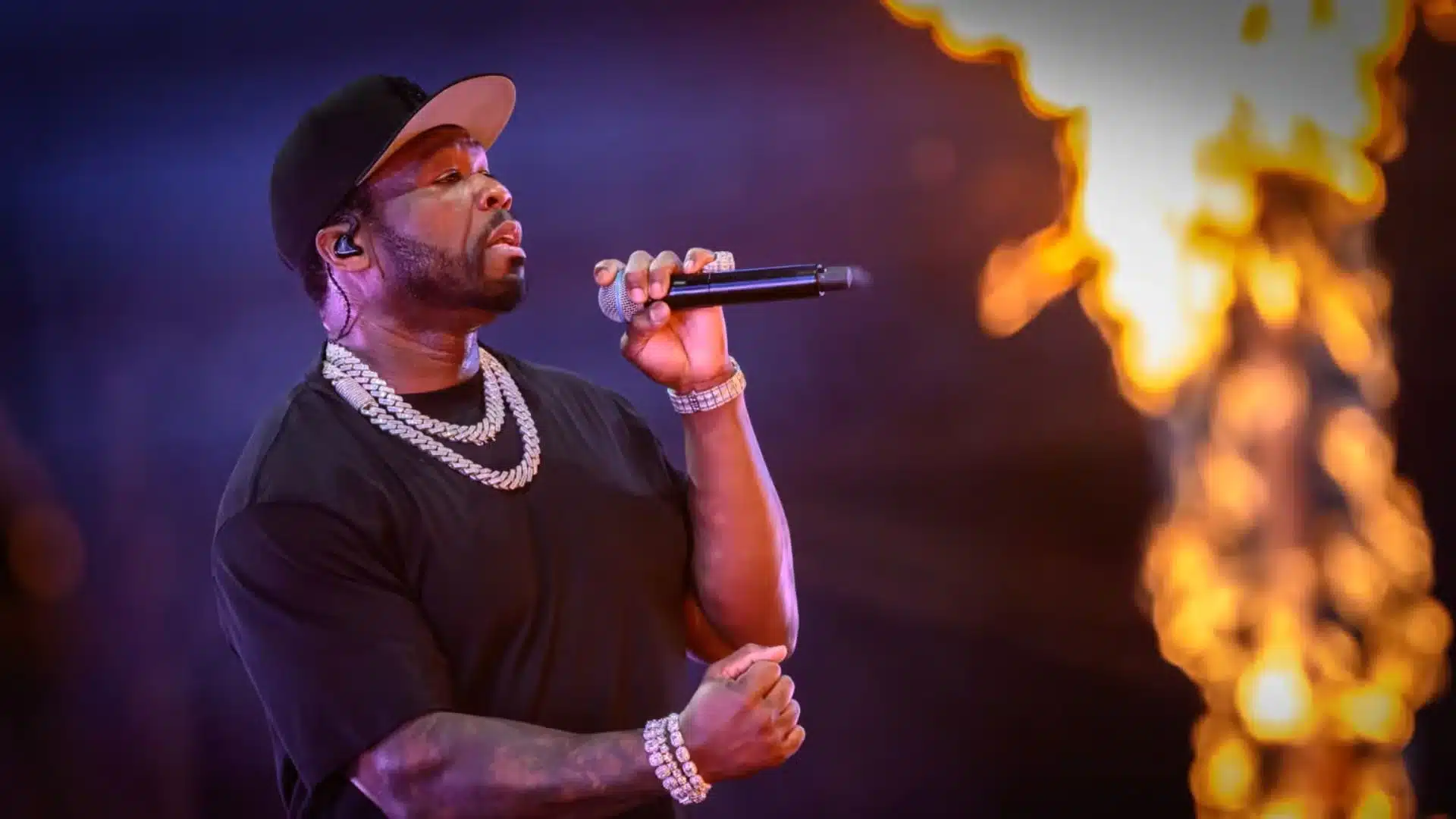 50 Cent performing onstage with a microphone