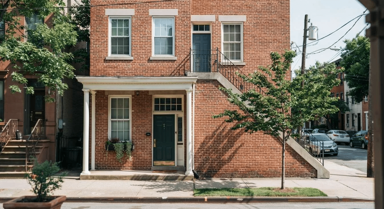 Stacked duplex with one home above another in an urban neighborhood.