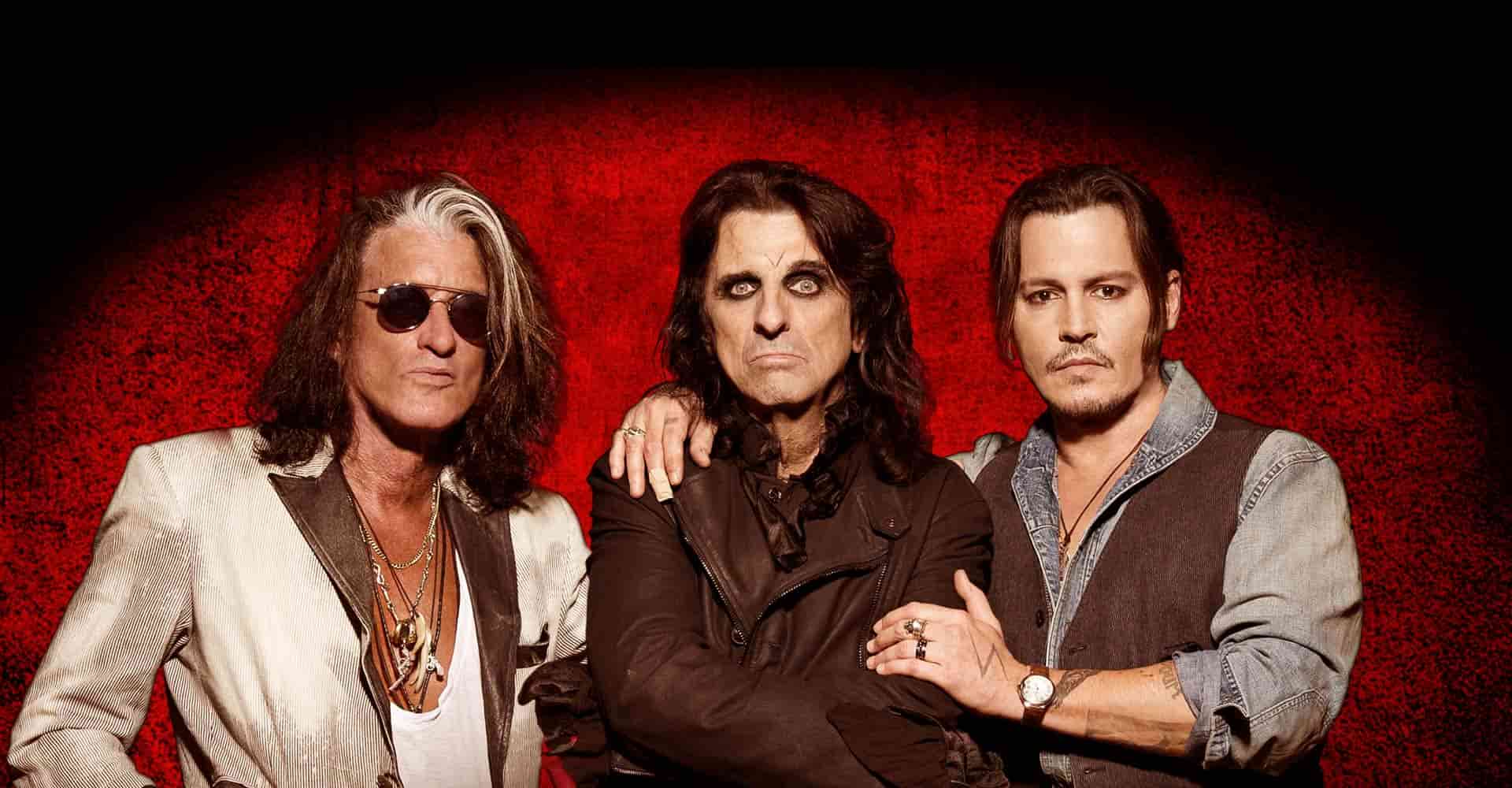 Joe Perry, Alice Cooper, and Johnny Depp posing together as the rock band Hollywood Vampires.
