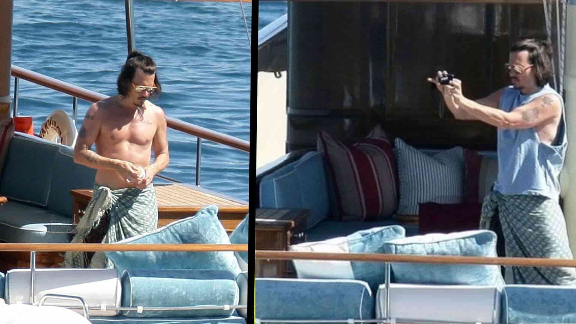 Johnny Depp relaxing and taking photographs aboard a luxury yacht at sea.