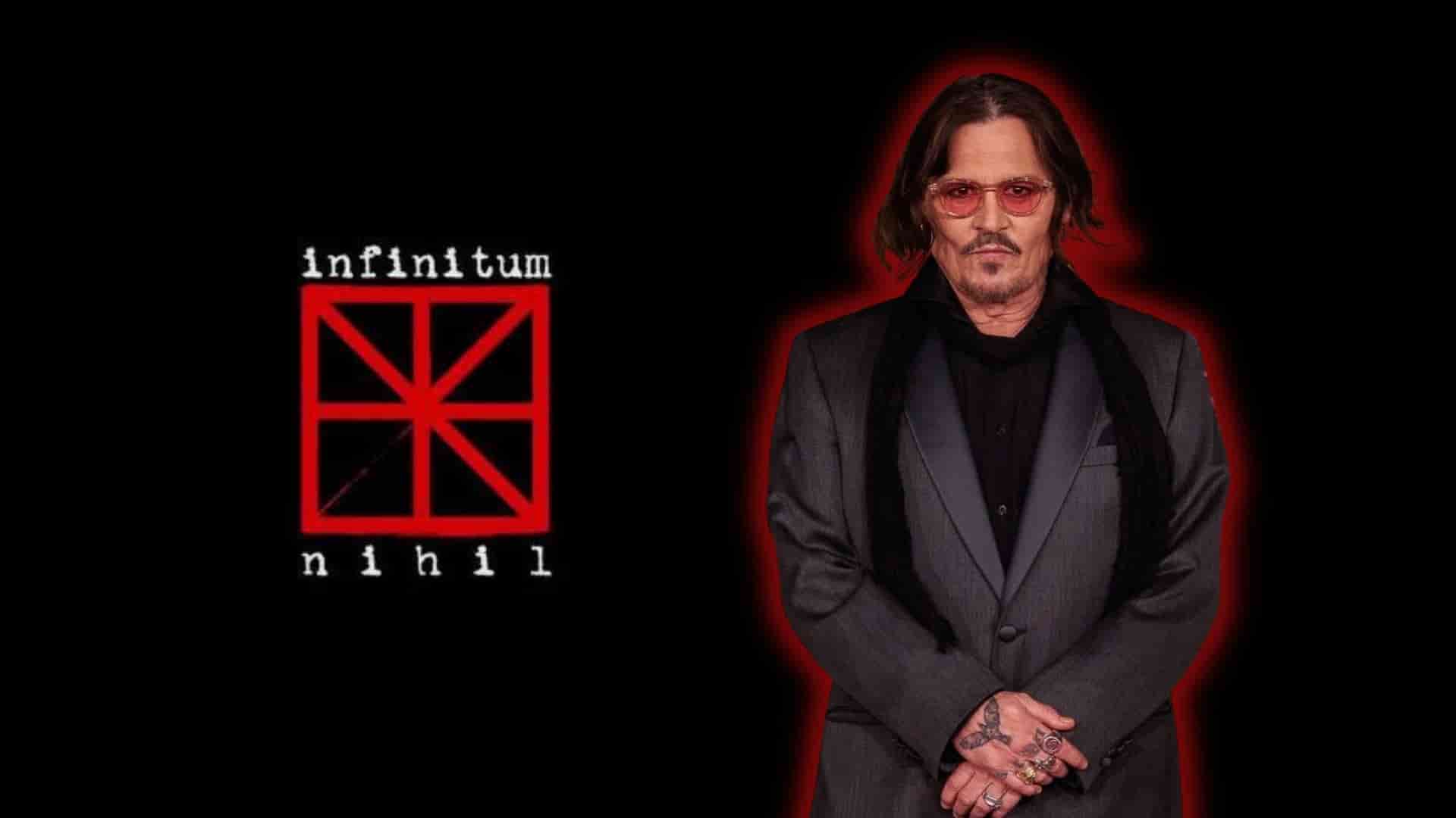 Johnny Depp standing beside the red and white logo of his production company, Infinitum Nihil.