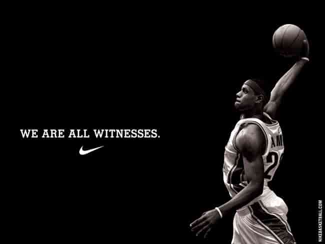 LeBron James holding Nike signature shoes during his lifetime partnership announcement