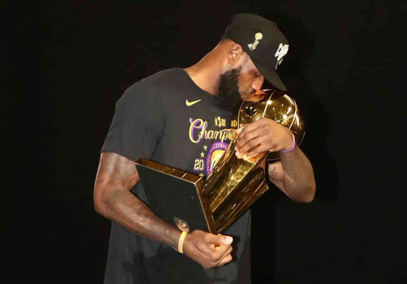 LeBron James holding the NBA championship trophy after winning a title