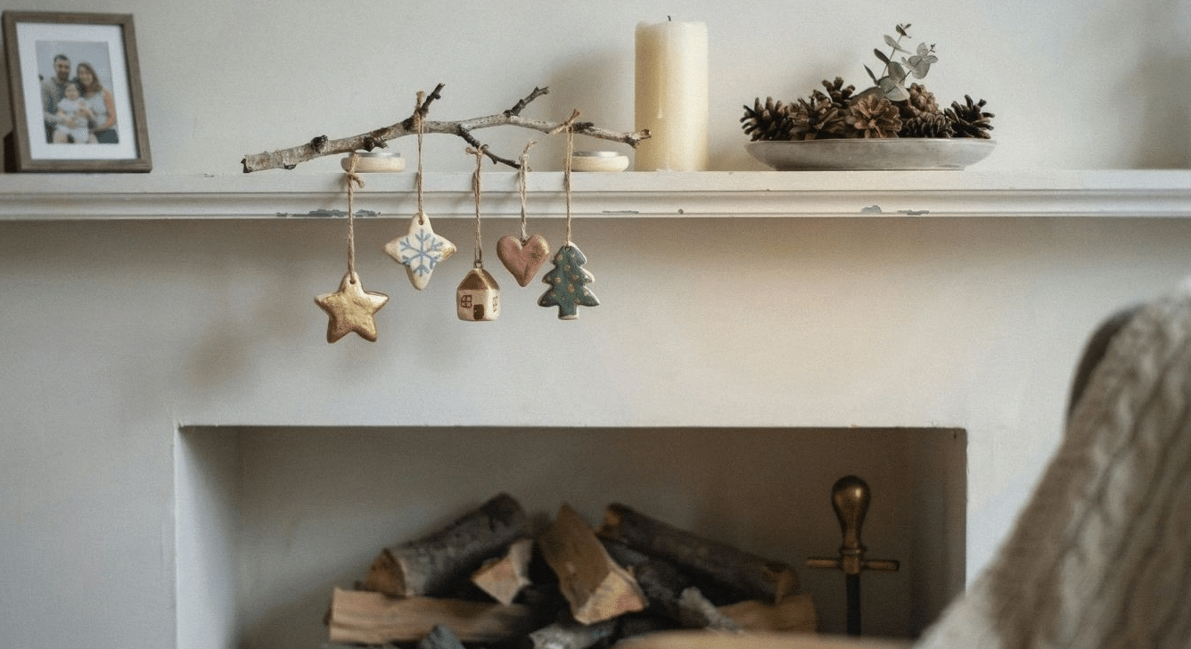 Painted salt dough ornaments hanging on a mantel display