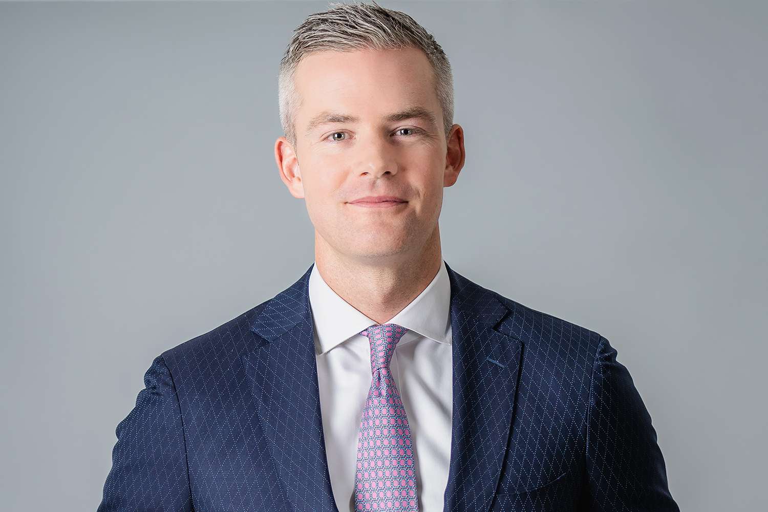 Ryan Serhant headshot in a blue suit and tie