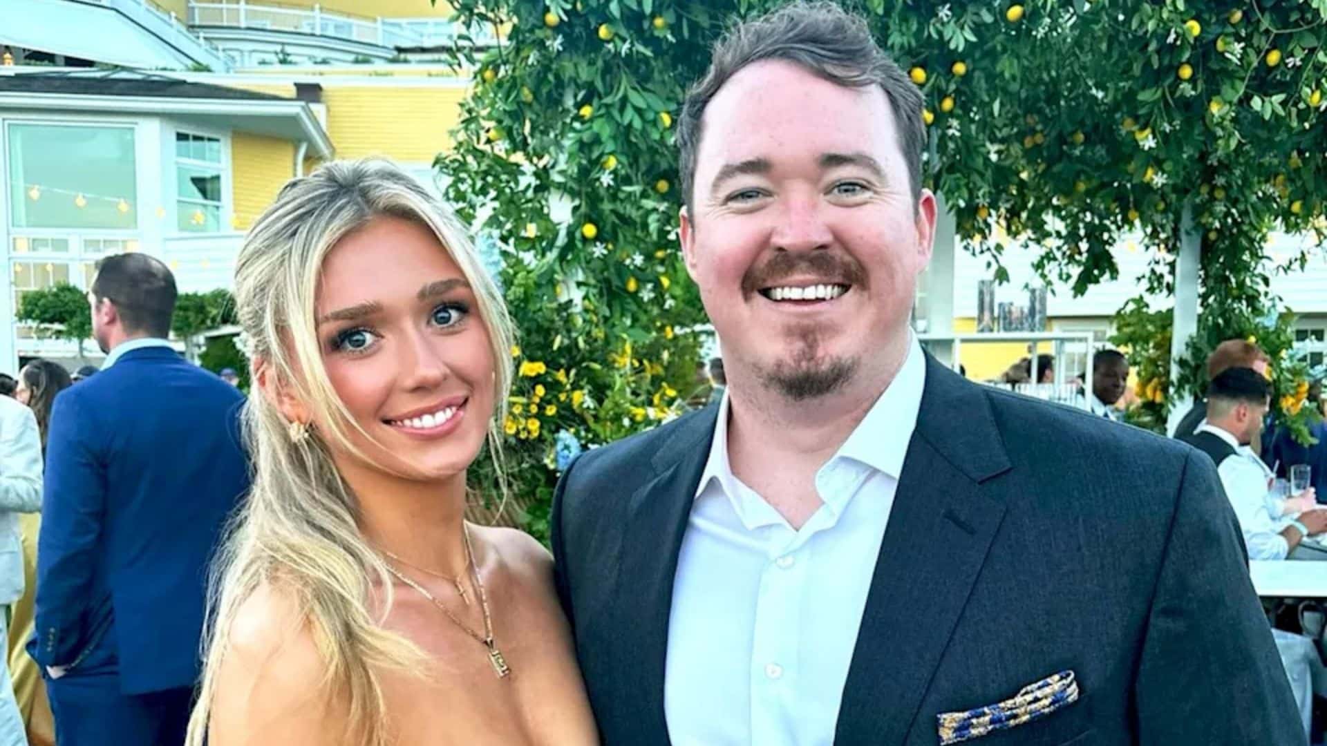 Shane Gillis and Grace Brassel smiling together at an outdoor event