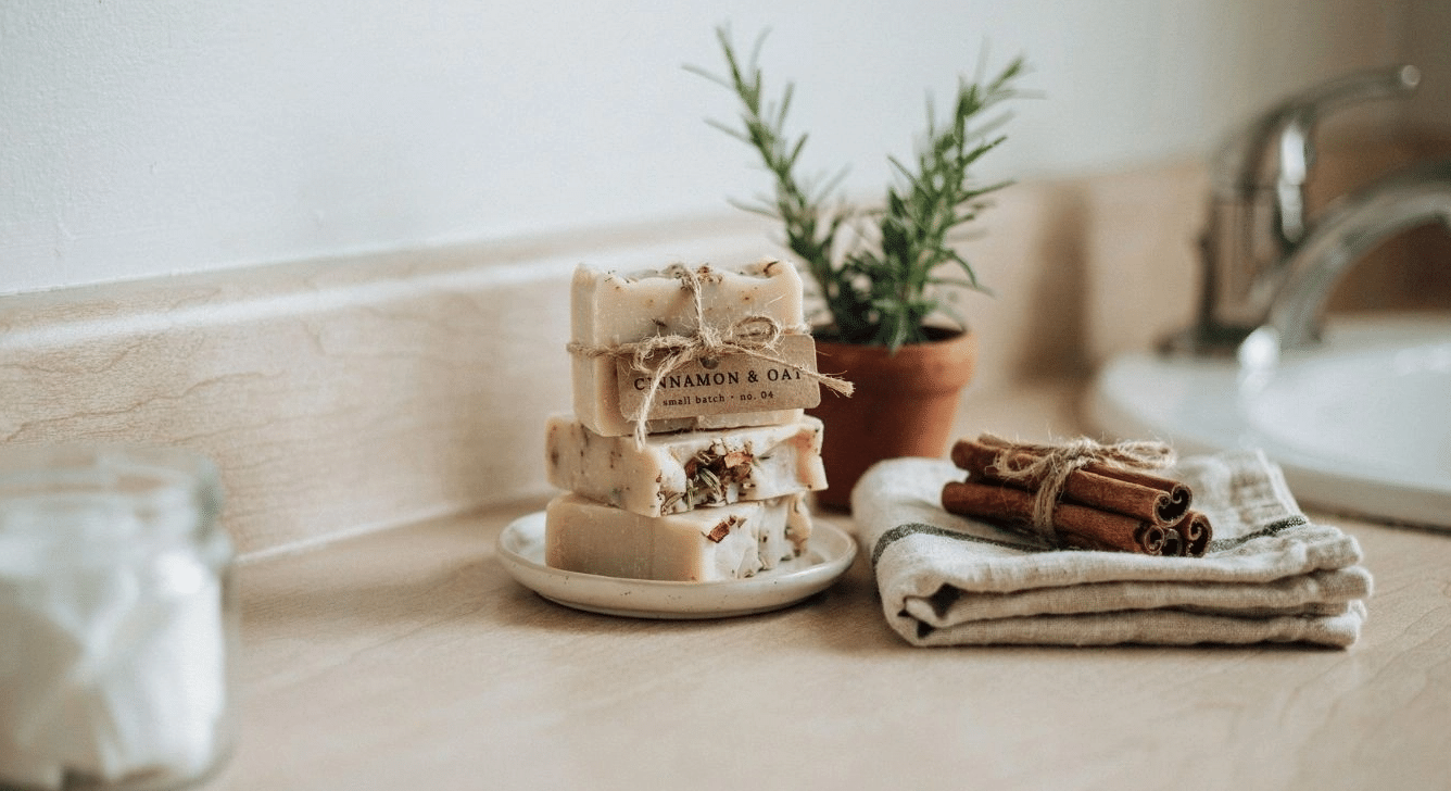 Stacked cinnamon-clove soap bars near a bathroom sink