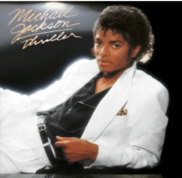 Thriller album cover featuring michael jackson in a white suit against a dark background.