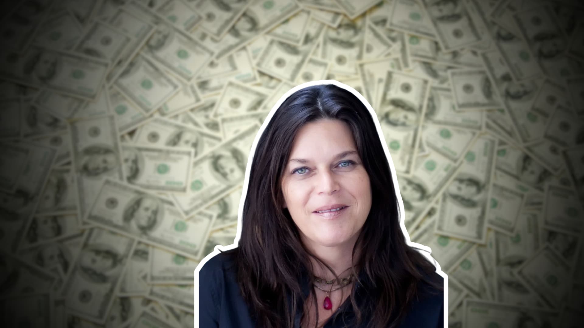 Annie Guthrie in a black shirt posing against a background of U.S. dollar bills.