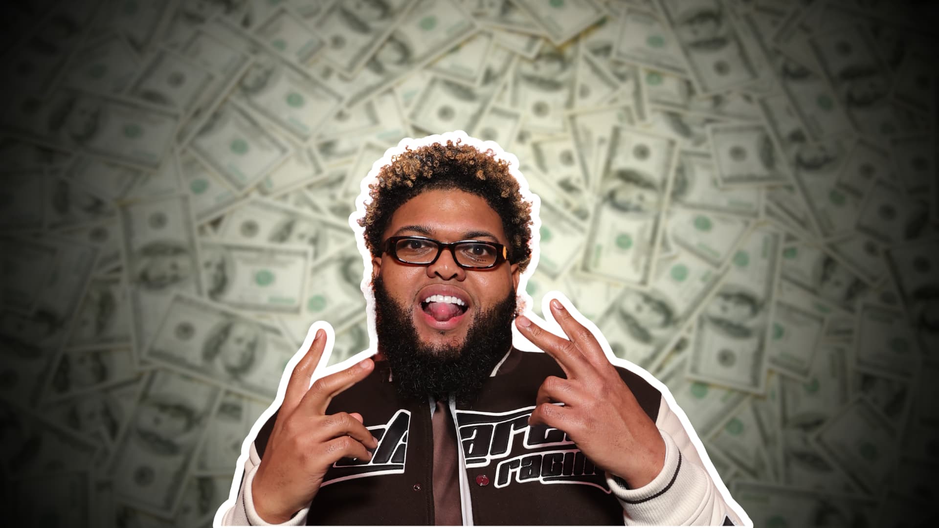 Druski posing for the camera against dollar bills in the background.
