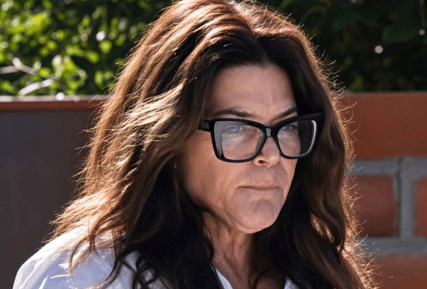 annie guthrie wearing a white shirt and glasses, spotted outside