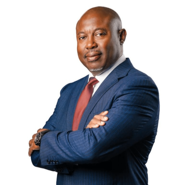 Simon guobadia in a blue suit posing against a white background
