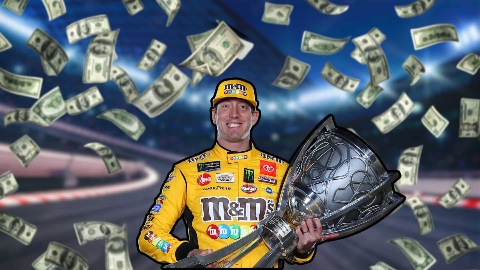 Kyle Busch in a yellow racing suit holding a trophy as dollar bills fall around him.