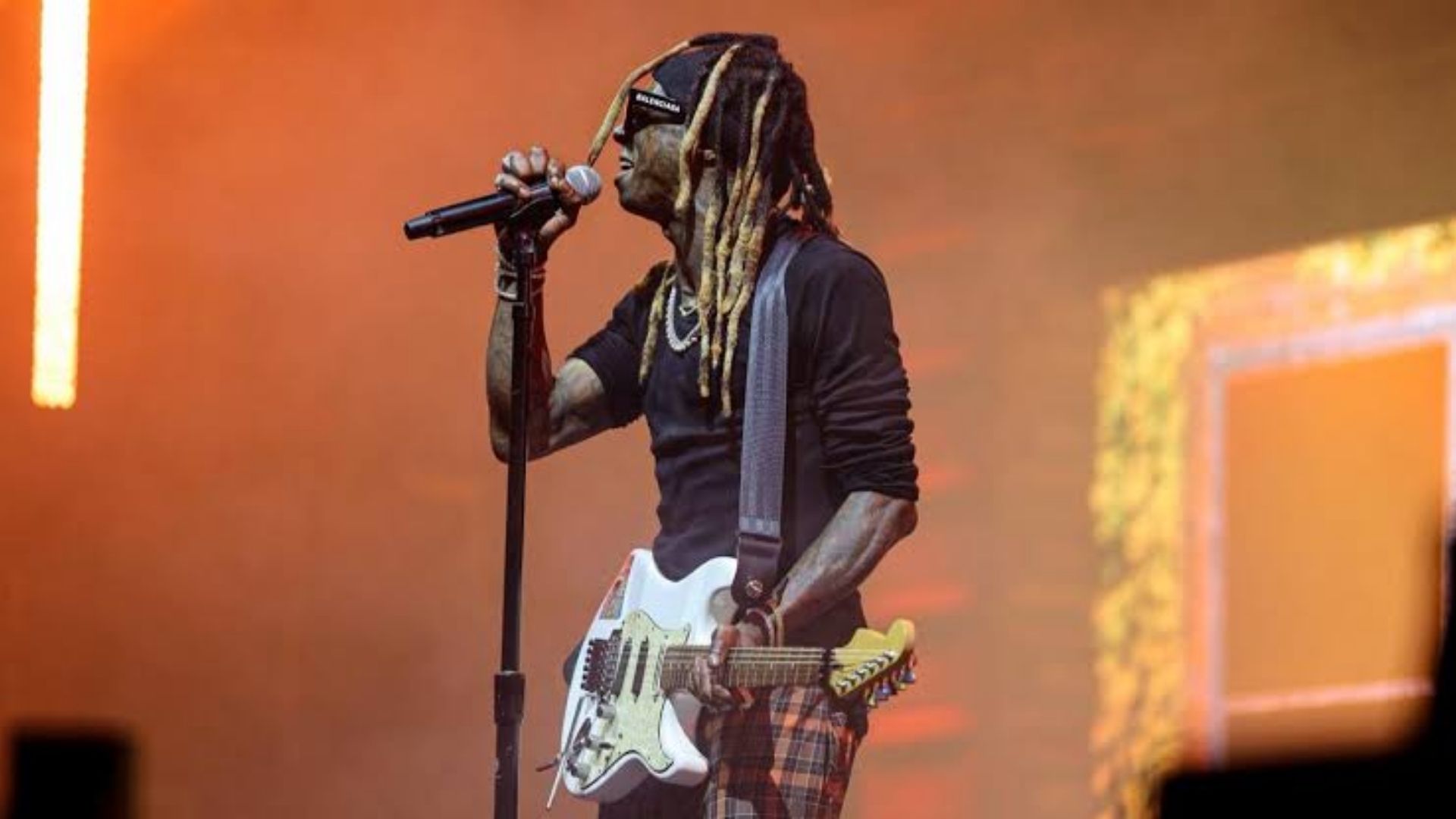Lil Wayne performing live on stage during a concert tour