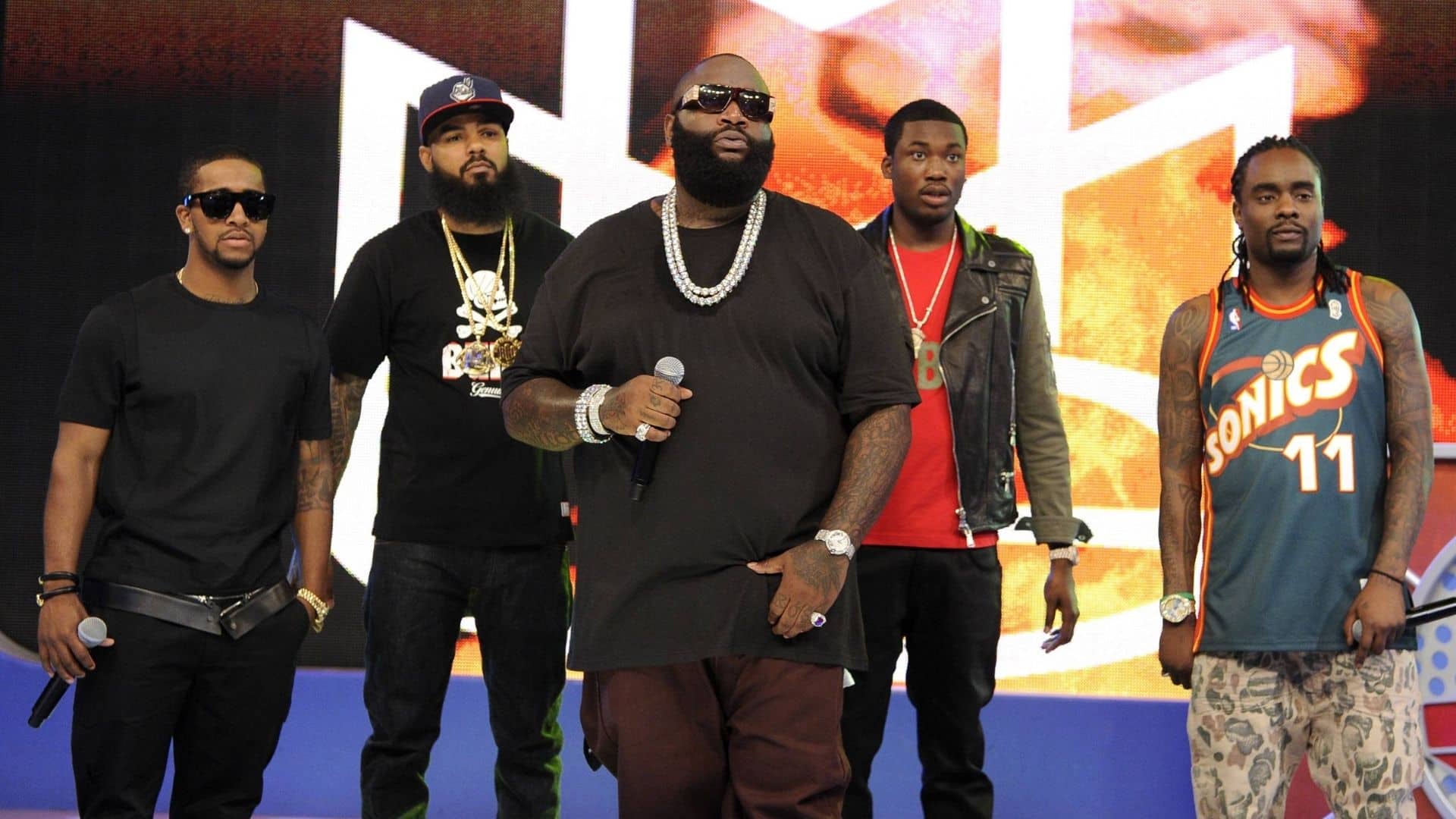 Rick Ross performing onstage with artists from Maybach Music Group