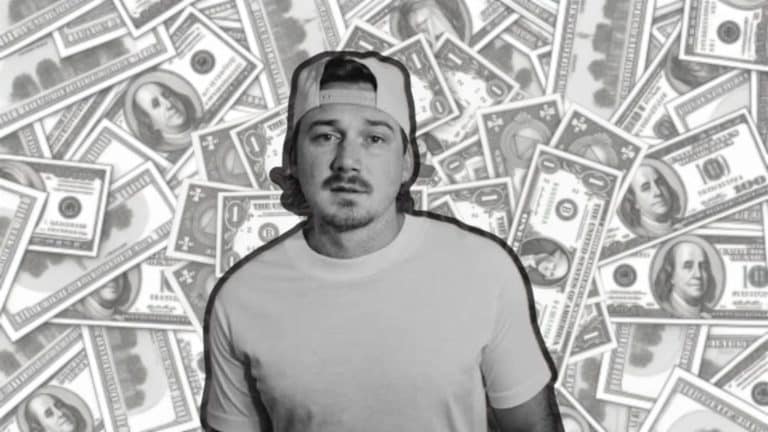 Black-and-white image of a Morgan Wallen in a cap standing in front of scattered dollar bills.