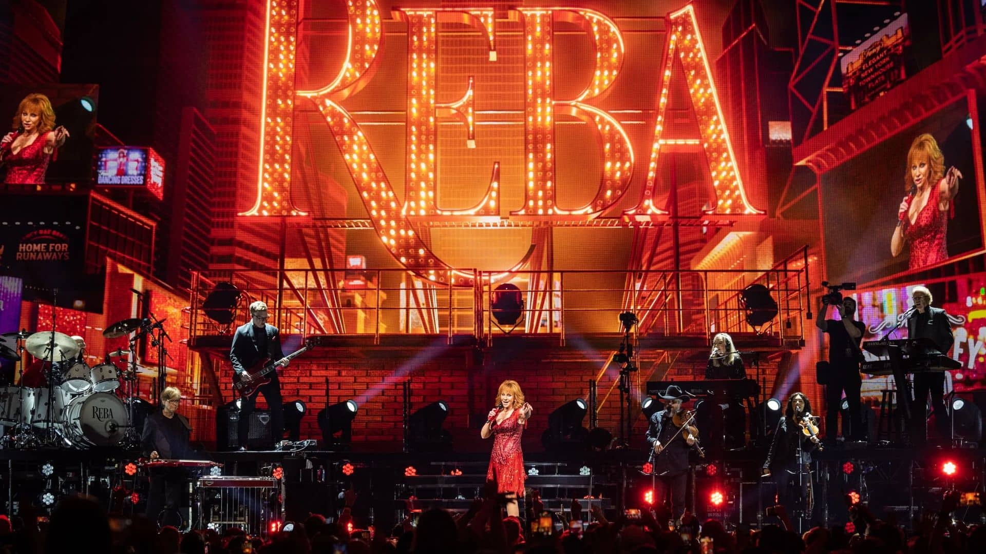 Reba McEntire performing live on stage under concert lights