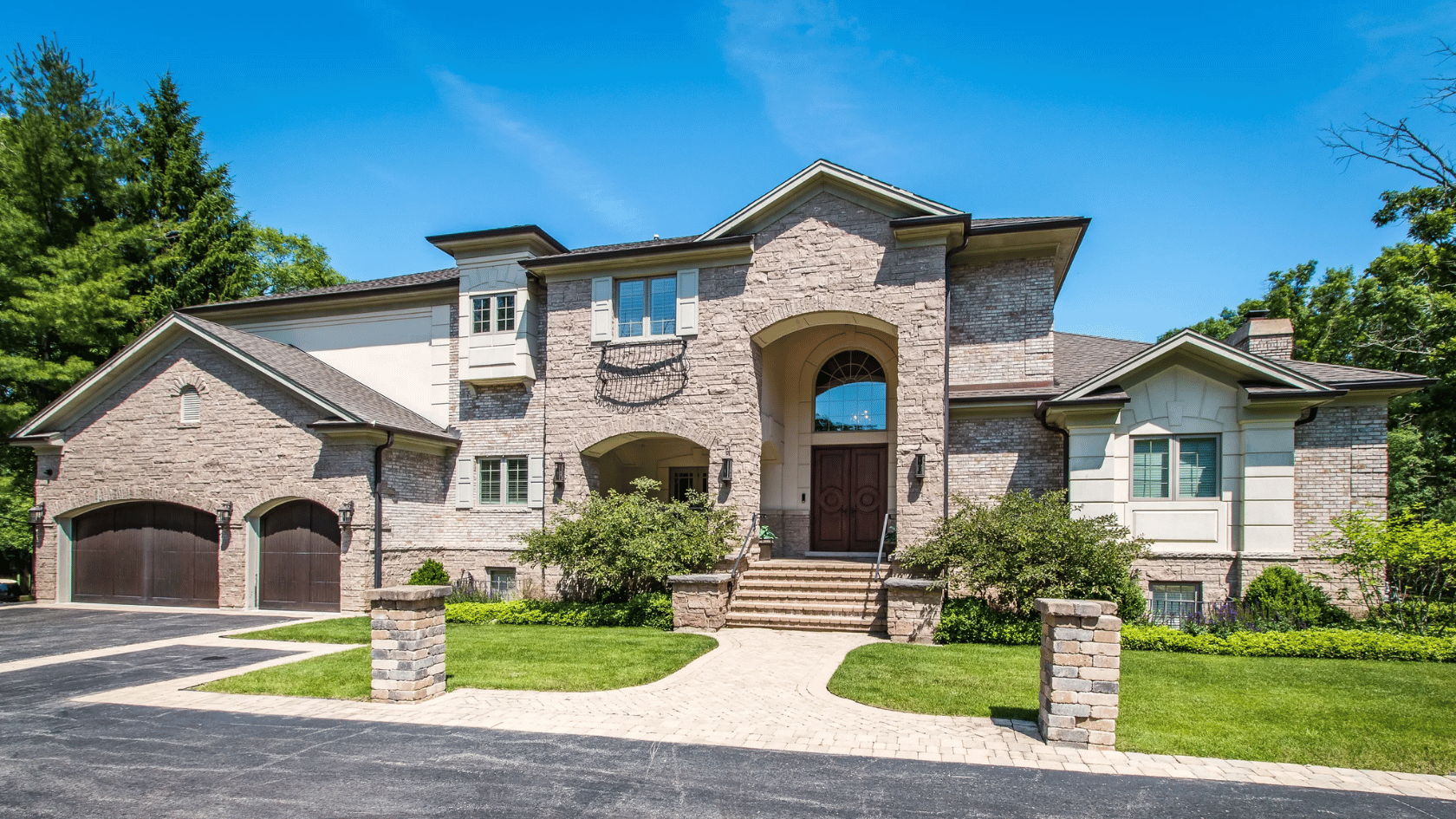 Scottie Pippen's luxury stone house with landscaped lawn and driveway.