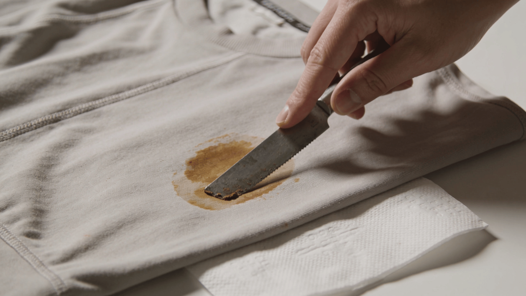 How to get paint out of clothes by scraping dried residue off fabric with a knife