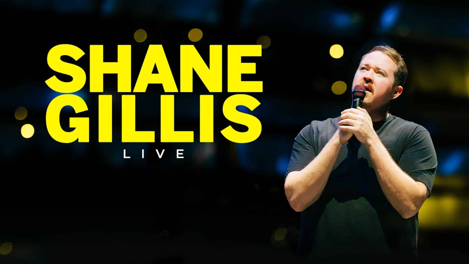 Shane Gillis performing stand-up comedy during a live comedy tour show