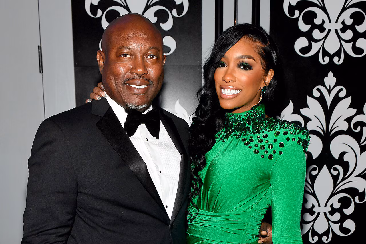 Simon Guobadia and Porsha Williams smiling together at a formal event