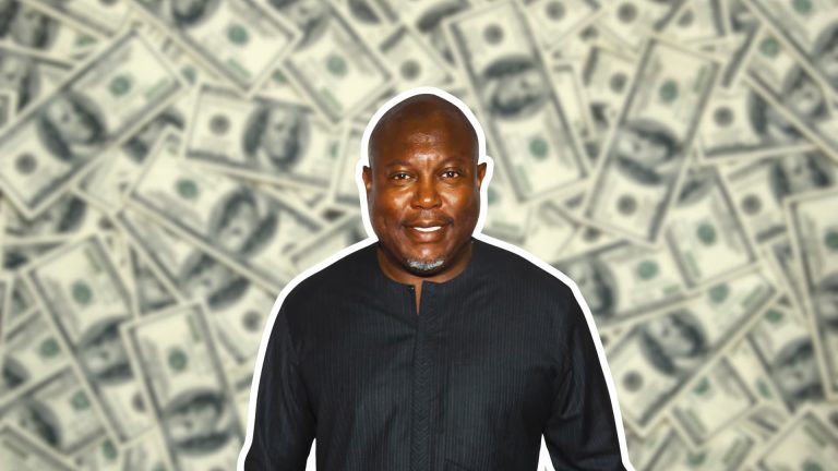 Simon Guobadia standing with blurred dollar bills in the background representing his net worth and business success.