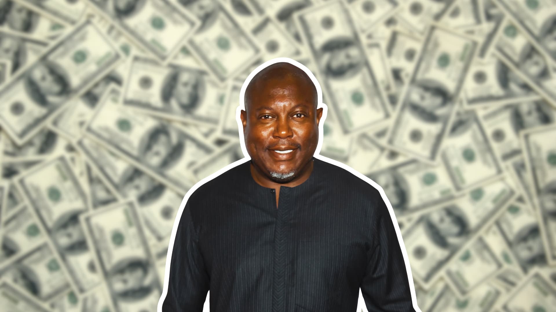 Simon Guobadia standing with blurred dollar bills in the background representing his net worth and business success.