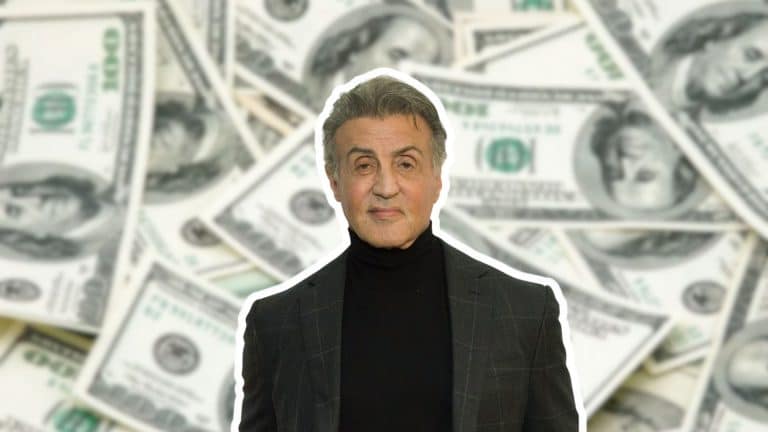 Sylvester Stallone standing against a background of dollar bills representing his net worth and success.