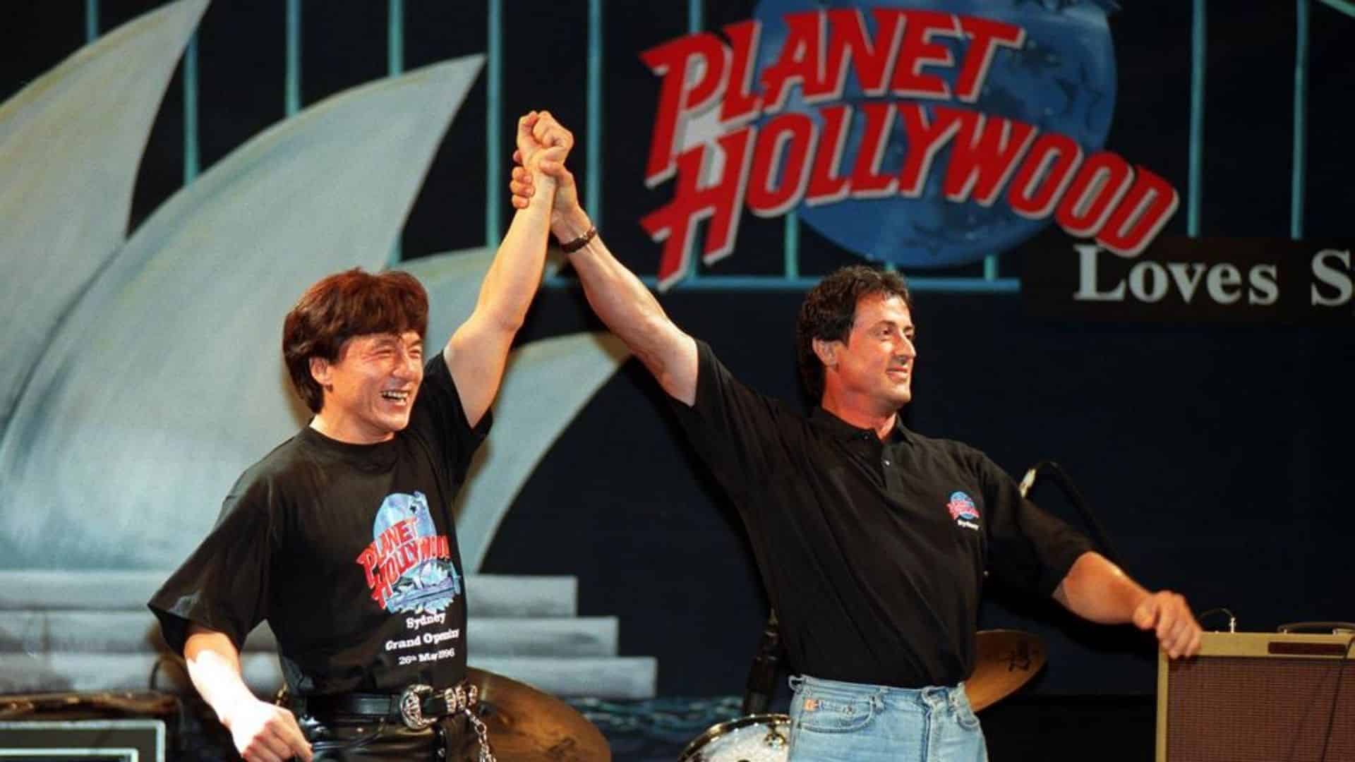 Sylvester Stallone with Jackie Chan at a Planet Hollywood event showcasing his business ventures.