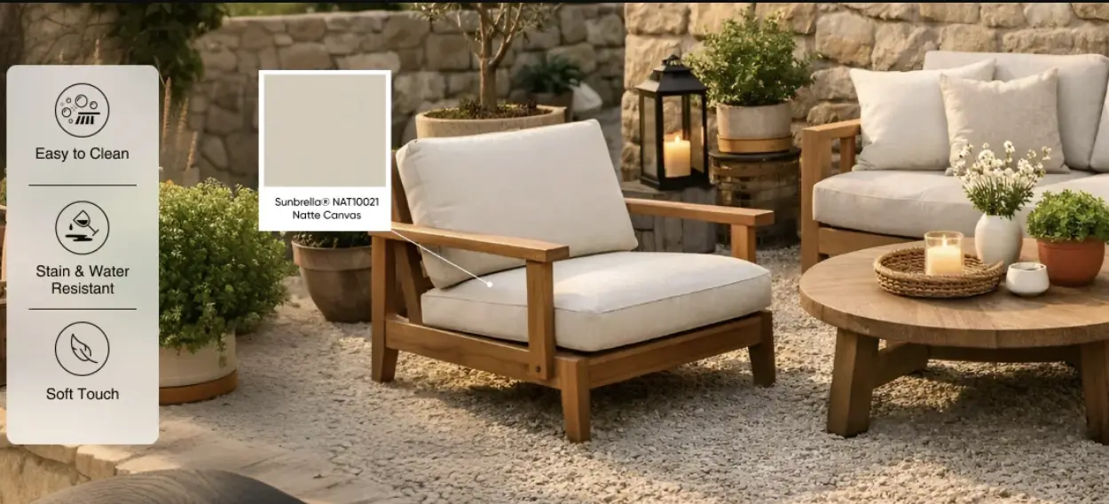 Outdoor patio with wooden furniture and beige cushions surrounded by plants and lit candles